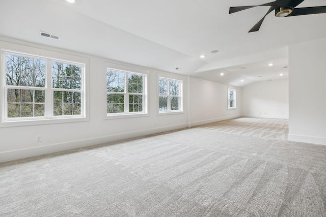 spare room featuring lofted ceiling, light carpet, and ceiling fan