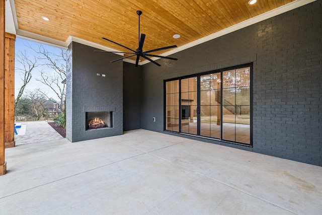 view of patio featuring ceiling fan and a fireplace