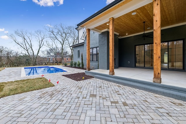 view of pool featuring a patio, ceiling fan, and french doors