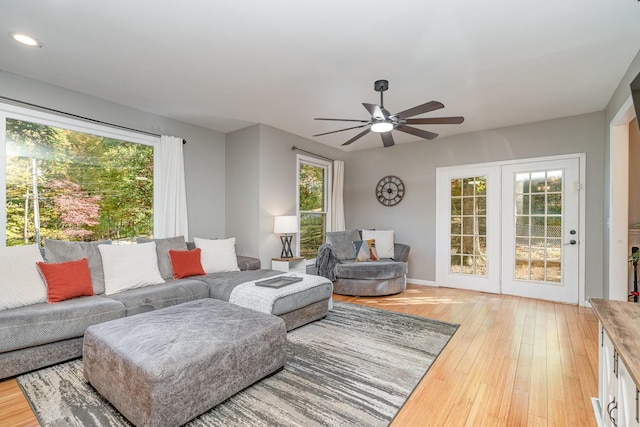 living room featuring a wealth of natural light, light hardwood / wood-style floors, and ceiling fan