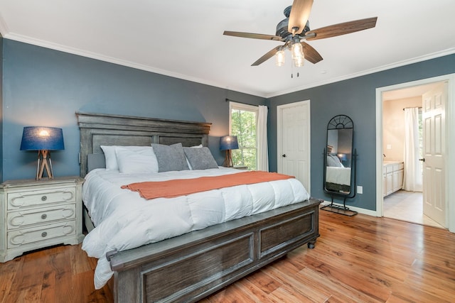 bedroom featuring crown molding, ensuite bathroom, ceiling fan, and light wood-type flooring