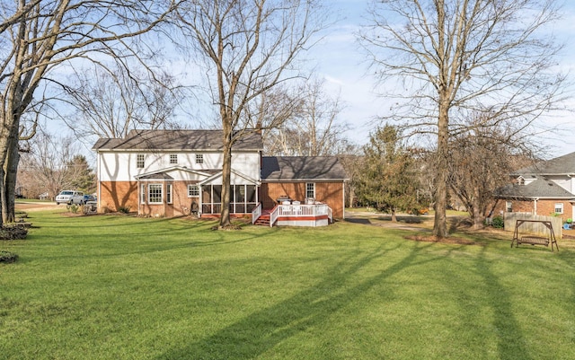 rear view of property with a lawn