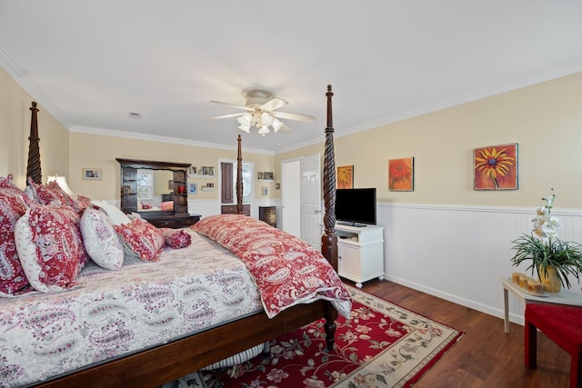 bedroom with crown molding, dark wood-type flooring, and ceiling fan