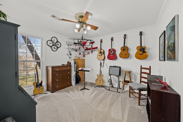 sitting room featuring crown molding, light colored carpet, and ceiling fan