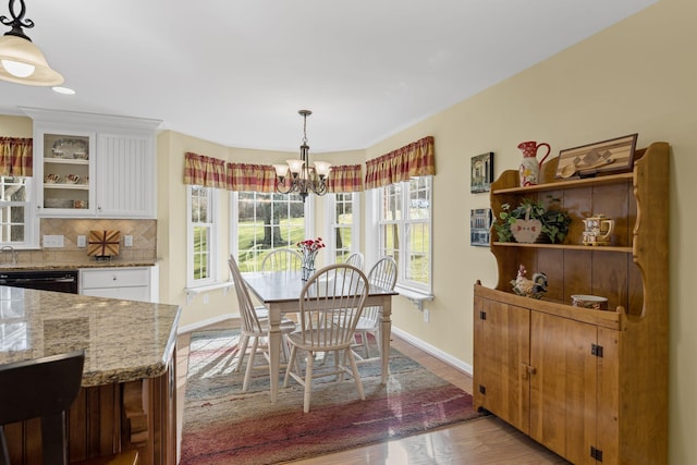 dining space with an inviting chandelier and wood-type flooring