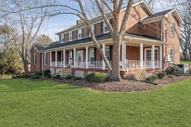 view of front of property featuring a porch, a front lawn, and central air condition unit