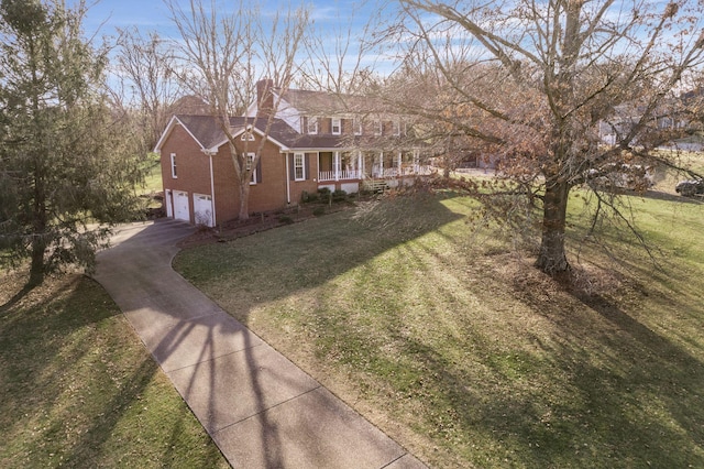 view of front facade featuring a garage, a porch, and a front lawn