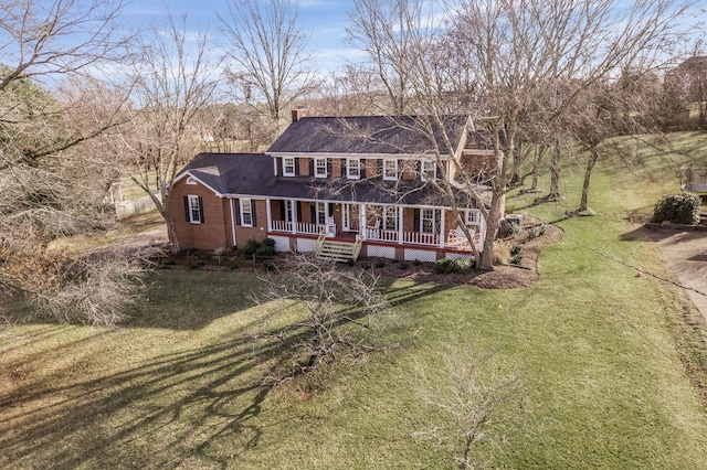 colonial house with a front lawn and a porch