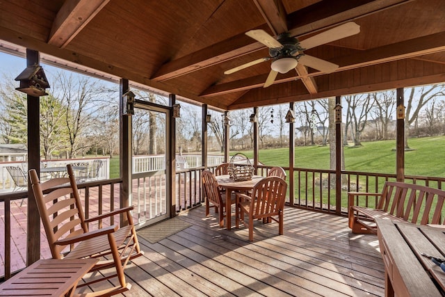 sunroom featuring lofted ceiling with beams, wood ceiling, and ceiling fan