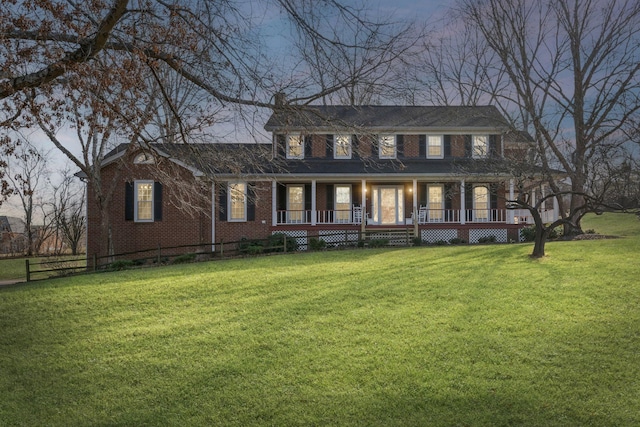 view of front of house with a lawn and a porch