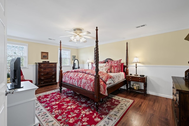 bedroom with ornamental molding, dark hardwood / wood-style floors, and ceiling fan