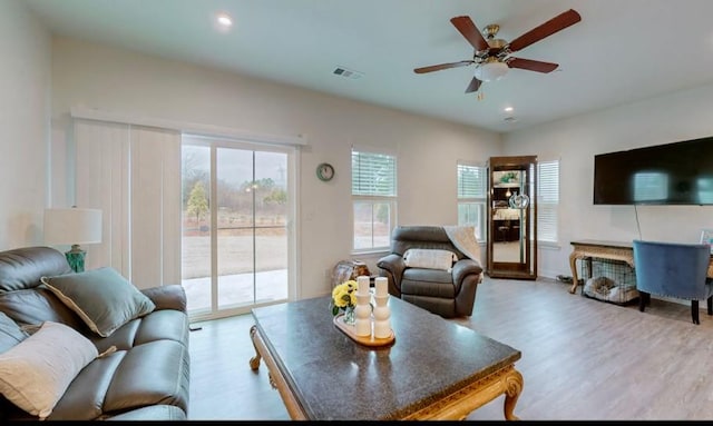 living room featuring light hardwood / wood-style flooring and ceiling fan