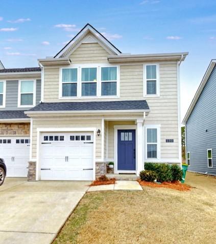 view of front of property with a garage and a front yard