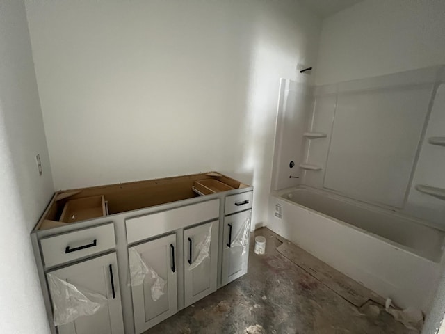 bathroom featuring vanity, concrete flooring, and bathing tub / shower combination