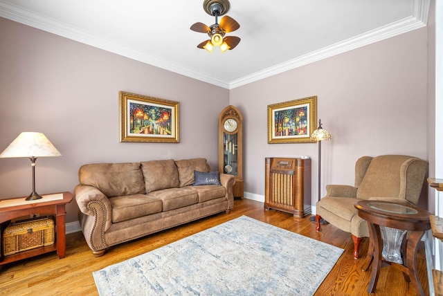 living room with hardwood / wood-style floors, crown molding, and ceiling fan