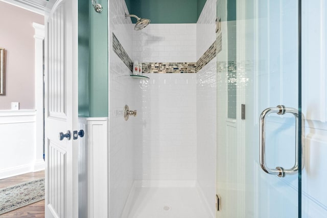 bathroom featuring a shower with door and hardwood / wood-style floors