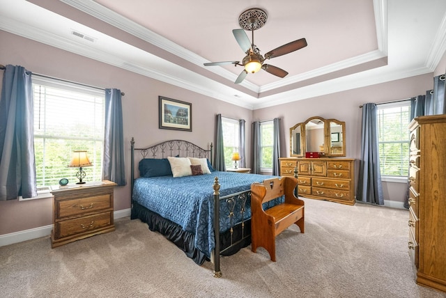 carpeted bedroom featuring ornamental molding, a raised ceiling, and ceiling fan