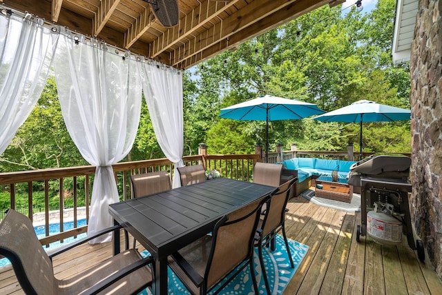 wooden deck with outdoor lounge area, a grill, and ceiling fan