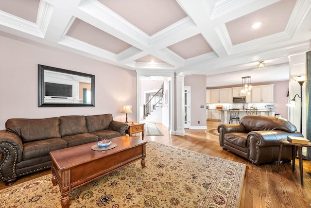 living room with coffered ceiling, beam ceiling, light hardwood / wood-style flooring, and ornate columns