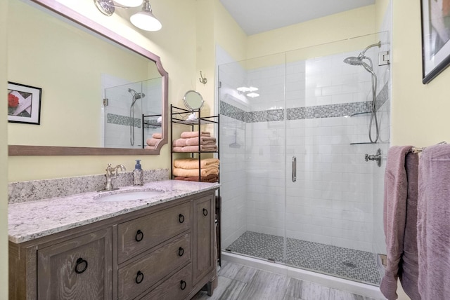 bathroom featuring vanity and an enclosed shower