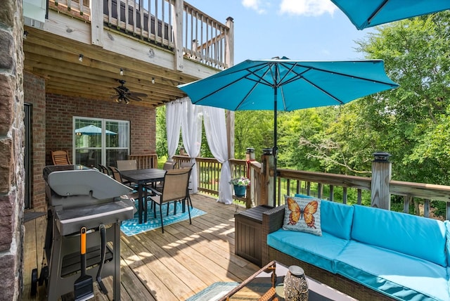 wooden deck featuring ceiling fan and an outdoor living space