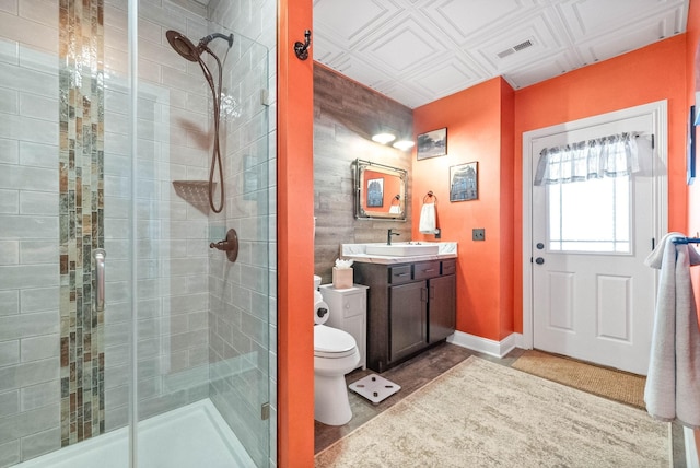 bathroom with vanity, an enclosed shower, and toilet