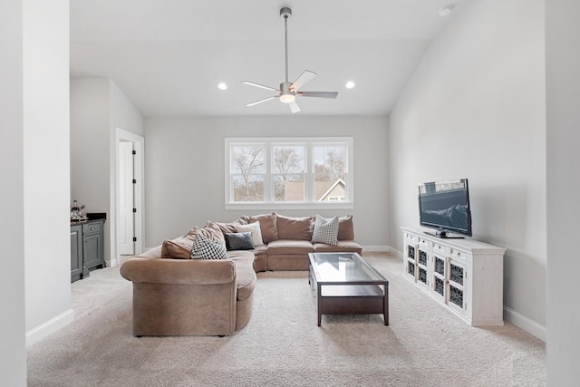 living room featuring ceiling fan, vaulted ceiling, and light carpet