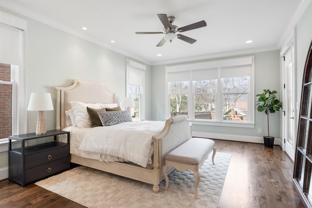 bedroom featuring ornamental molding, wood-type flooring, and ceiling fan