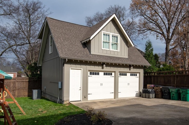 garage with a yard and central air condition unit