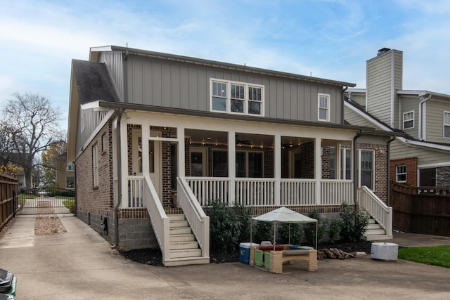 rear view of house featuring a porch