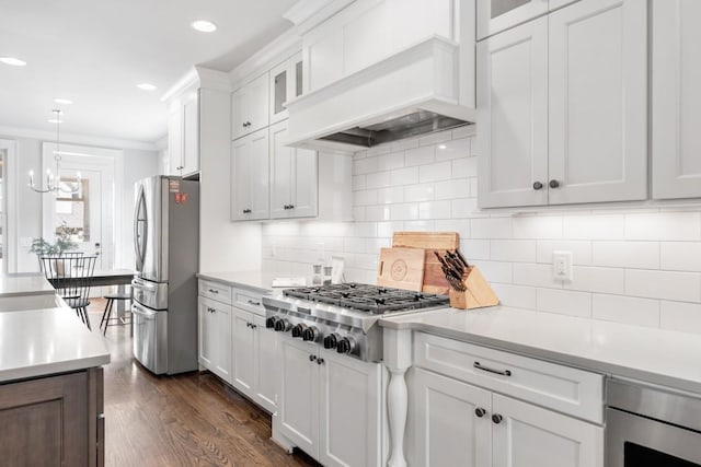 kitchen with appliances with stainless steel finishes, custom range hood, and white cabinets