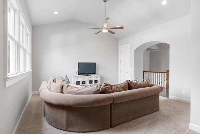 living room featuring ceiling fan, lofted ceiling, and carpet flooring