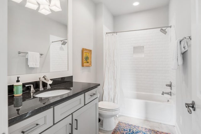 full bathroom with vanity, shower / bath combo, and toilet