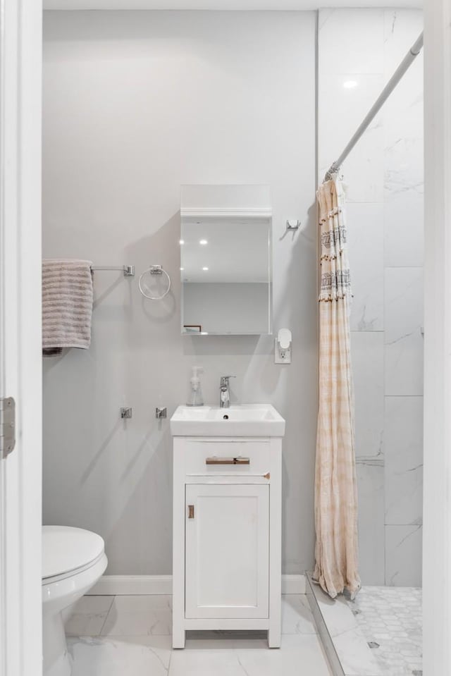 bathroom featuring vanity, curtained shower, and toilet