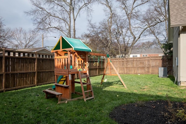 view of jungle gym with a yard and central air condition unit