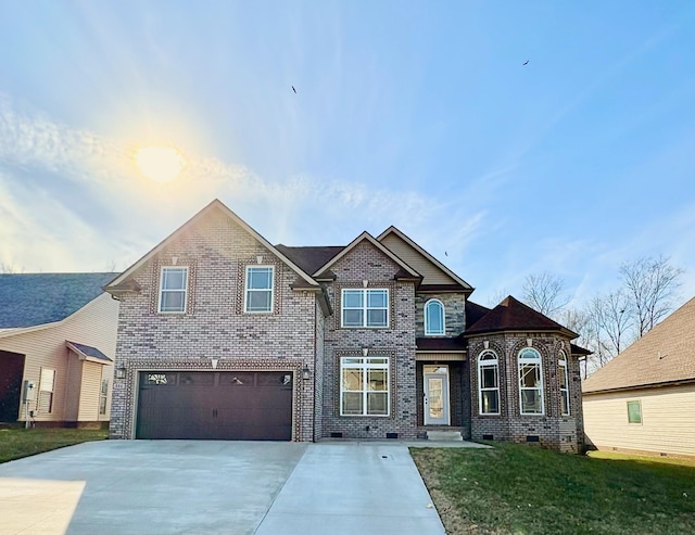 view of front of home featuring a garage and a front yard