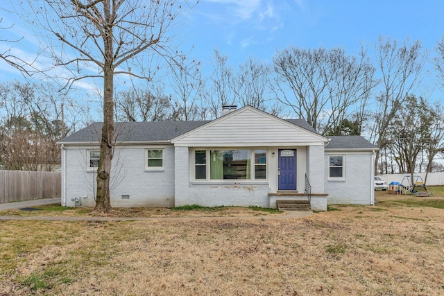 view of front of home featuring roof with shingles, brick siding, crawl space, and fence