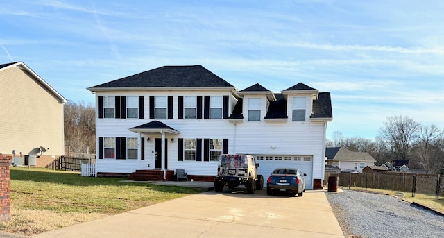 view of front of property featuring a garage and a front yard