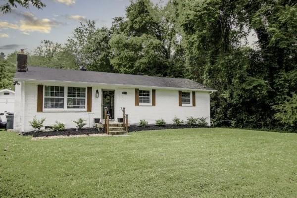 ranch-style home featuring a front yard