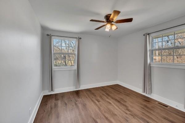 spare room featuring hardwood / wood-style floors and ceiling fan