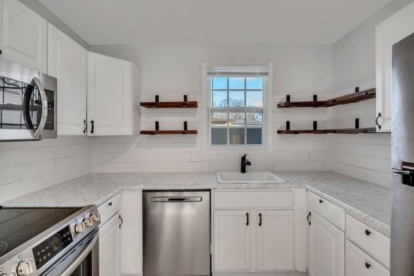 kitchen featuring white cabinetry, appliances with stainless steel finishes, and sink