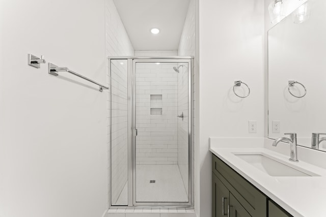 bathroom with vanity and a shower with door