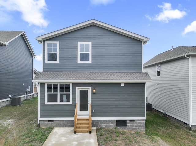 back of house featuring a yard and central AC unit