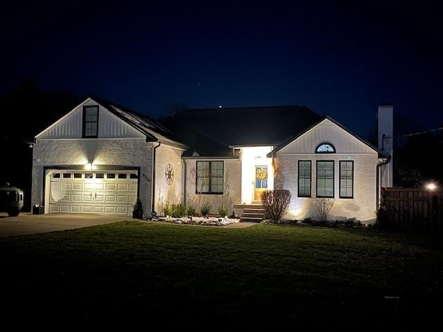 view of front facade featuring a garage and a lawn