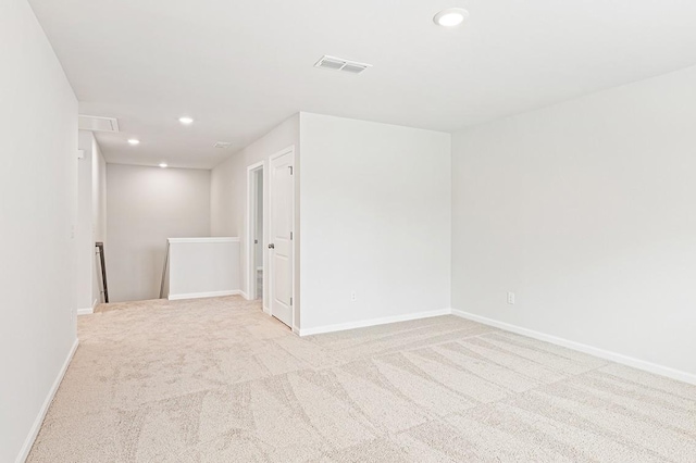 unfurnished room with light carpet