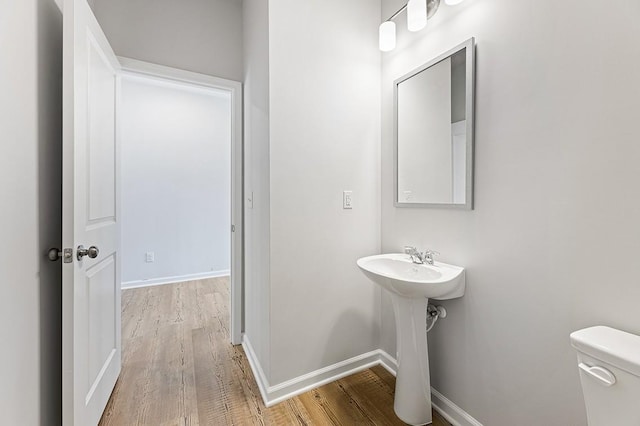 bathroom featuring hardwood / wood-style flooring, sink, and toilet