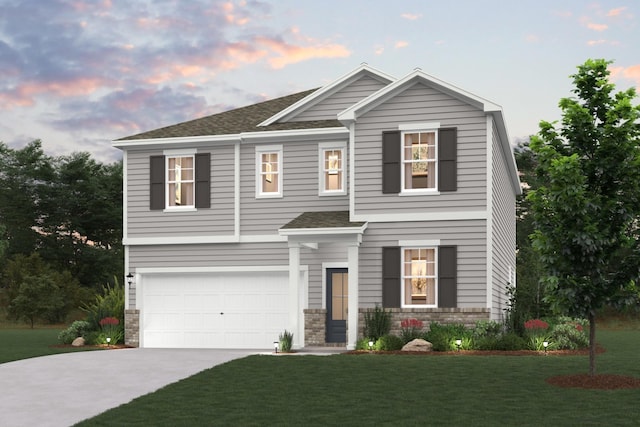 view of front facade featuring a garage and a yard