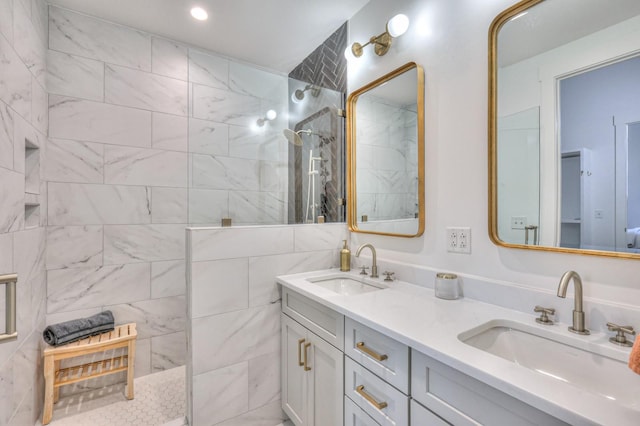 bathroom featuring a tile shower and vanity