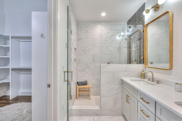 bathroom featuring vanity and a tile shower