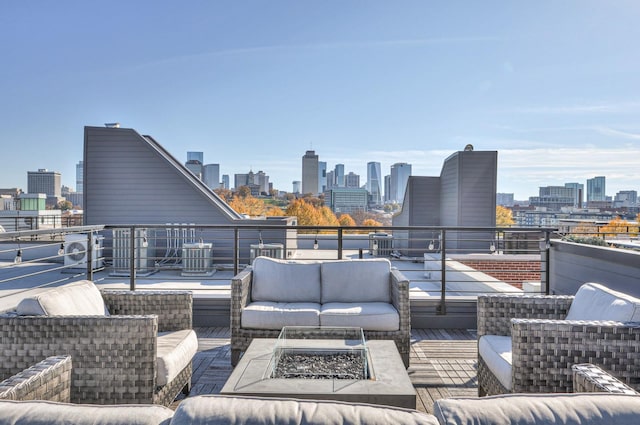 view of patio featuring central AC and an outdoor living space with a fire pit